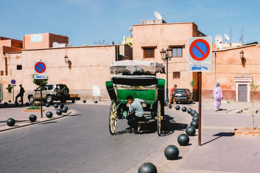 Boy hitching a ride in Marrakech