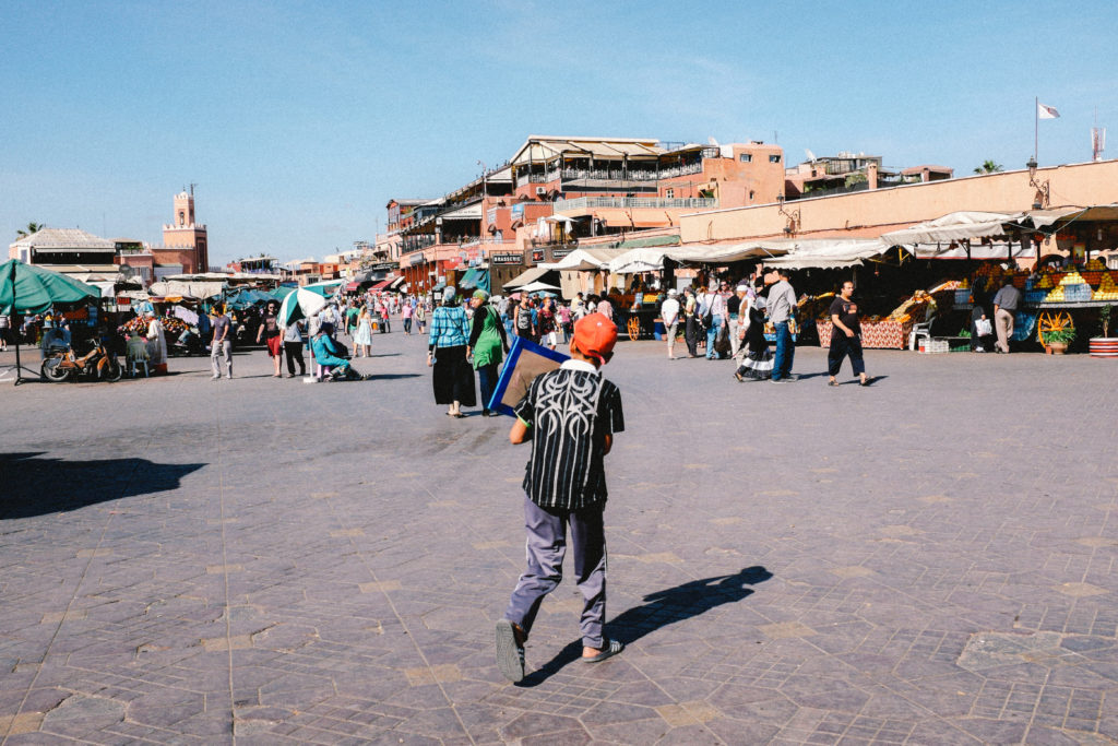 Boy running through the Jemaa El Fnaa square on Marrakech